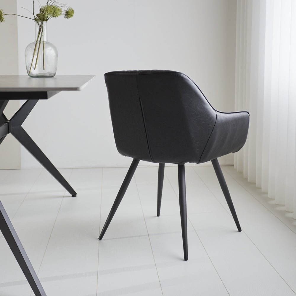 Dining room chair Cara Dimehouse Black LxWxH 78x65x57 Faux leather Atmospheric photo diagonal rear view