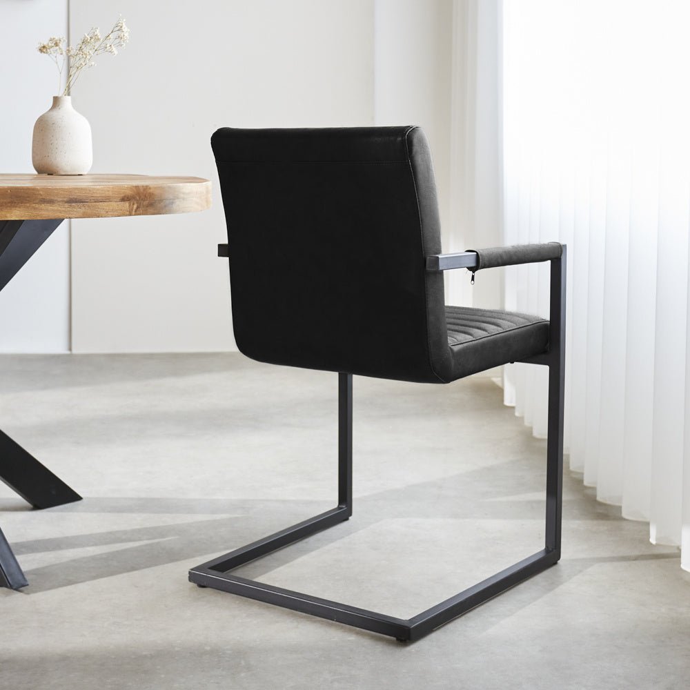Dining room chair Kuba Dimehouse Black LxWxH 71x59x58 Faux leather Atmospheric photo diagonal rear view