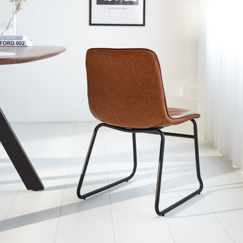 Dining room chair Mark Dimehouse Cognac LxWxH 74x56x54 Faux leather Atmospheric photo diagonal rear view
