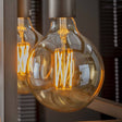 Light source LED filament Sphere Ø12.5 DH Interior Amber color glass LxWxH 18x13x13 Amber color glass Atmospheric photo diagonal front view