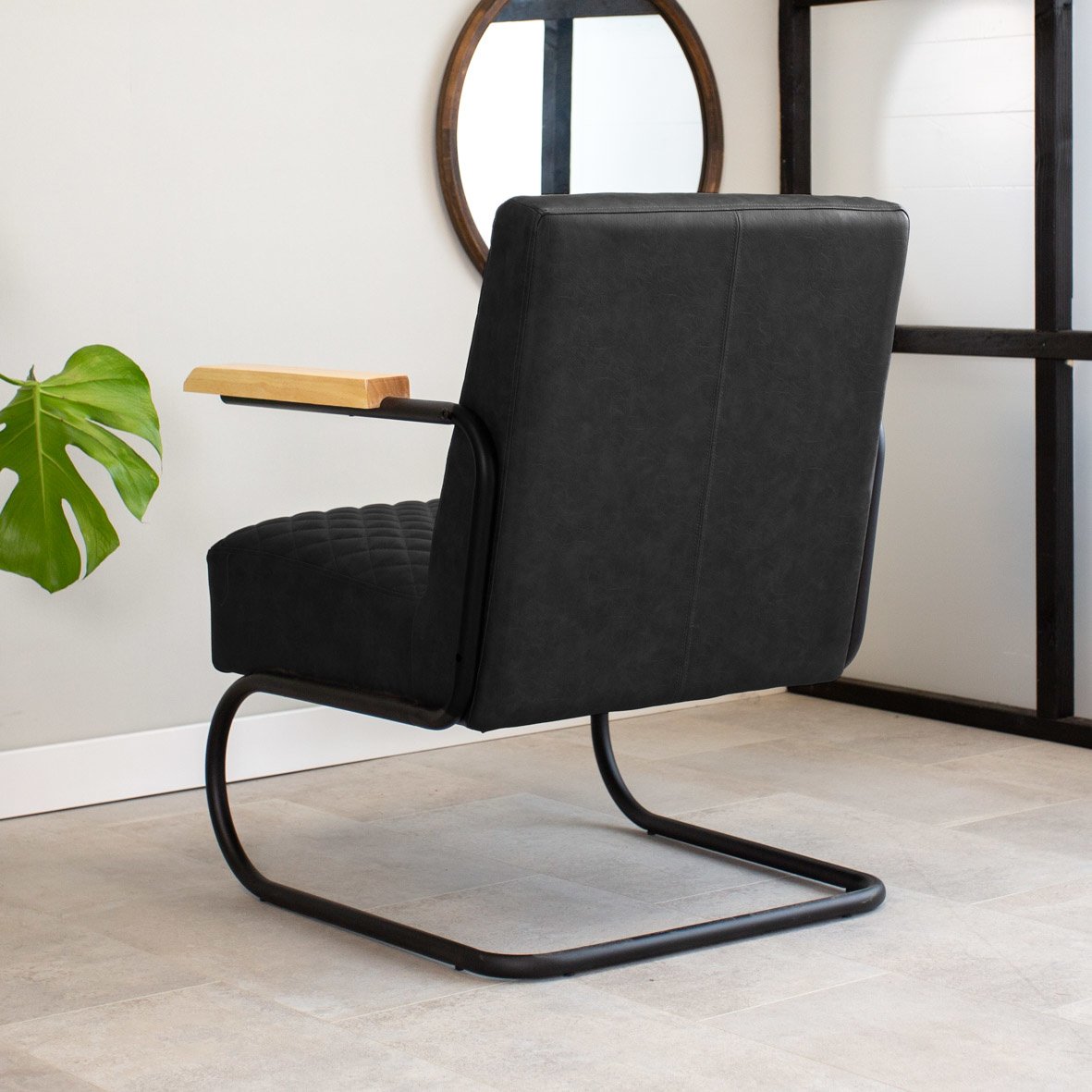 Armchair Lars Dimehouse Black LxWxH 68x64x39 Faux leather Atmospheric photo diagonal rear view